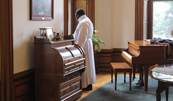 Transitional Deacon Ventius Agbasiere looks out the window during a moment of reflection before ceremonies for ordination to the diaconate at St. Joseph Cathedral.
(Patrick McPartland/Staff Photographer)