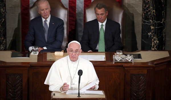 With Vice President Biden and House Speaker Boehner look on as Pope Francis addresses Congress in Washington, D.C.