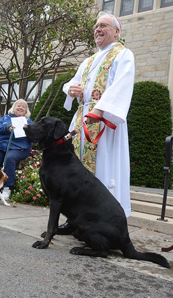 Bishop Richard J. Malone and his dog Timon outside the bishop's residence for the blessing of animals the day before the Feast of St. Francis. The tradition of blessing animals is conducted as a remembrance of St. Francis of Assisi's love for creation.