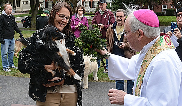 Darcy Fernandes gets a blessing from Bishop Richard J. Malone as she is held by Donna Fernandes during the blessing of animals on the front lawn of bishop's residence the day before the Feast of St. Francis. The tradition of blessing animals is conducted as a remembrance of St. Francis of Assisi's love for creation.