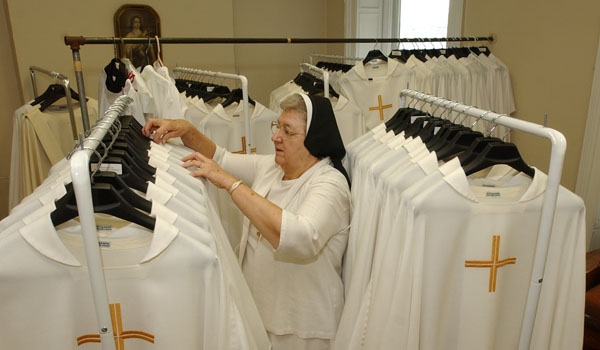 Cathedral sacristan, Sister Mary John Lawicki, CSSF, prepares dozens of vestments that will be worn by priests at Bishop Edward Kmiec's installation.