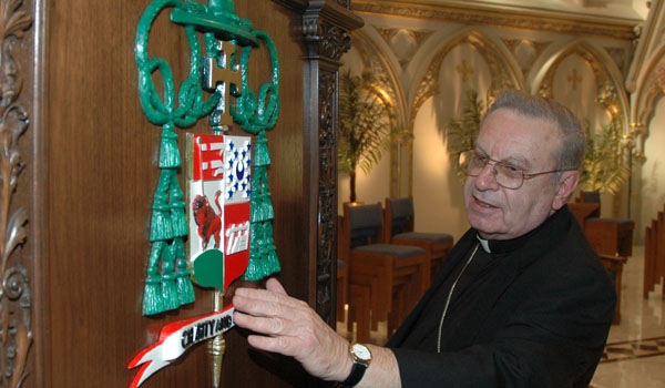 Bishop Edward Kmiec observes his coat of arms as it hangs on the back of the cathedra at St. Joseph's Cathedral in Buffalo. Bishop Kmiec rehearsed the process of installation on Tuesday, Oct. 26, 2004 at the Cathedral in Buffalo.