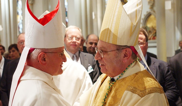 Auxiliary Bishop Edward Grosz (left) welcomes incoming Bishop Edward Kmiec at the door of St. Joseph's Cathedral before the start of the Installation Mass. 