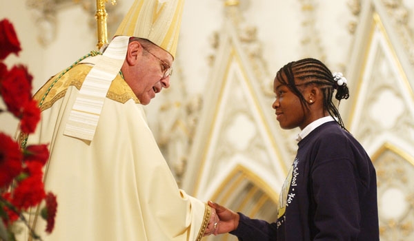 Lauren Clarke (right), an eighth-grader at St. Aloysius School in Cheektowaga, greets Bishop Edward Kmiec during liturgical ceremonies at St. Joseph Cathedral. 