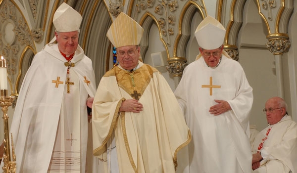 Bishop Edward Kmiec (center) is lead to the cathedra by Cardinal Edward Egan (left), Archbishop of New York, and Bishop Gabriel Montalvo (right), Apostolic Nuncio to the United States during the Installation Mass.