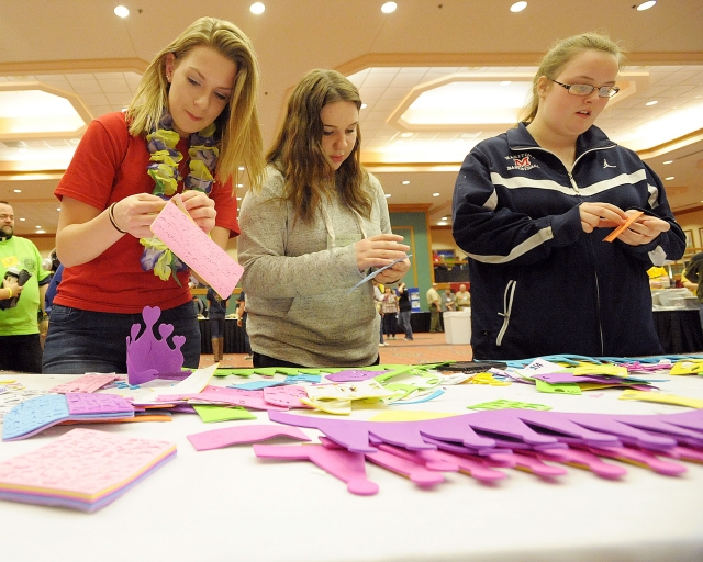 Allison DeMartin, Alexandra Kiblin and Josephine Leising create crowns for patients Roswell Park and Children's Hospital at the 64th Annual Diocesan Youth Convention.