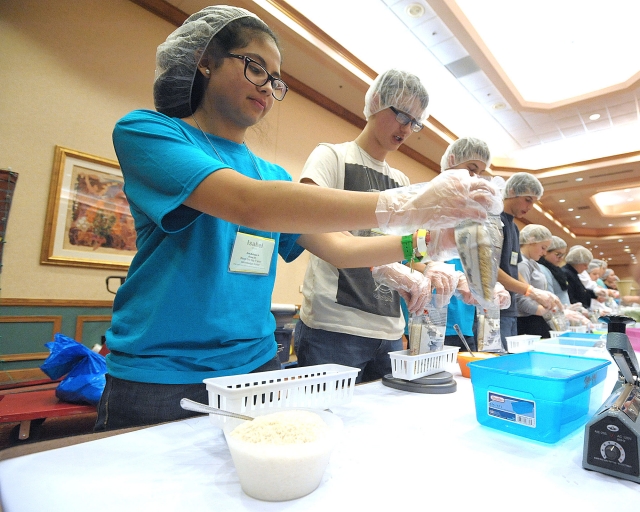 Volunteers fill bags of food for Stop Hunger Now, a partnership with Catholic Relief Services at the 64th Annual Diocesan Youth Convention.