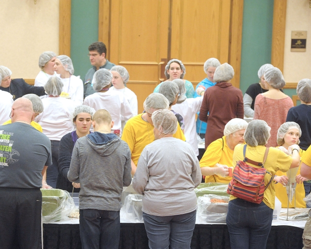 Volunteers fill bags of food for Stop Hunger Now, a partnership with Catholic Relief Services at the 64th Annual Diocesan Youth Convention.