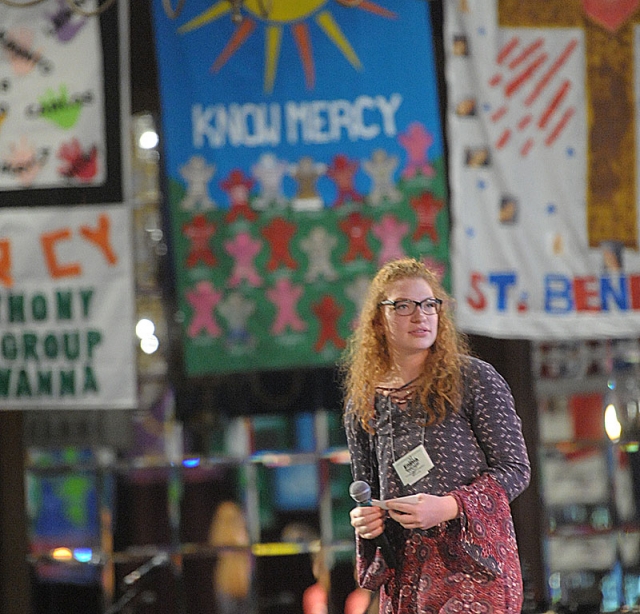Emma Okoniewski is surrounded by banners with the theme 