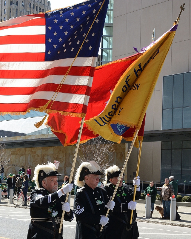 Flags flap in the wind as the Knight s of St. John walk at the 2016 St. Patrick's Day Parade.