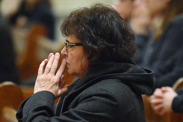 A woman sits in silent prayer during Evening Mass of the Lord's Supper, Holy Thursday, celebration at St. Joseph Cathedral.