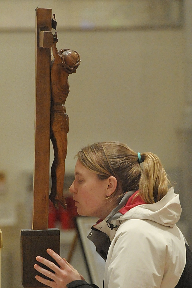 At the conclusion of Good Friday services at St. Joseph Cathedral, the faithful venerate the crucifix.