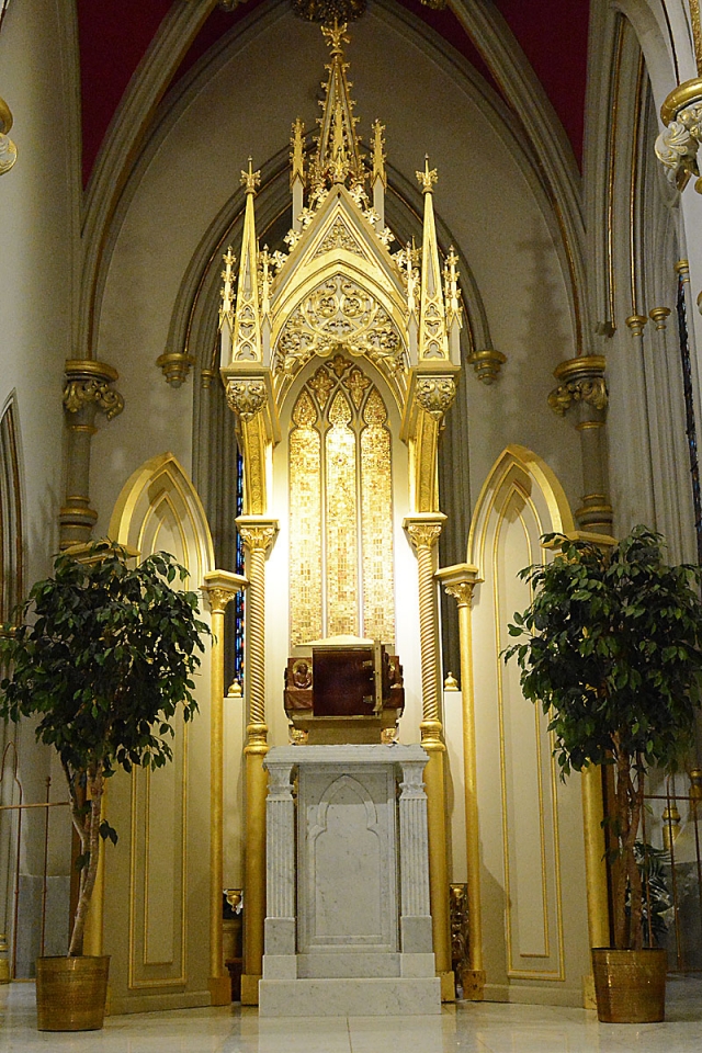 An empty tabernacle stands open, as if in mourning, signifying that Jesus has given Himself over to death during the Good Friday celebration at St. Joseph Cathedral.