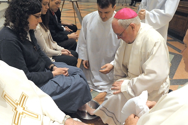 For the first time Bishop Richard J. Malone washes the feet of women during Evening Mass of the Lord's Supper, Holy Thursday, celebration at St. Joseph Cathedral.