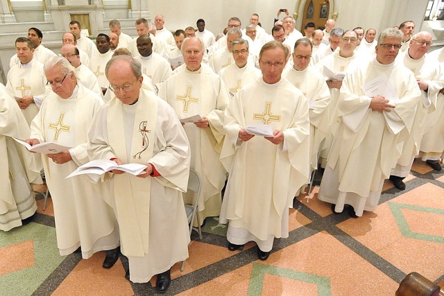 Diocesan priests renew their priestly promises during the Chrism Mass at St. Joseph Cathedral. 