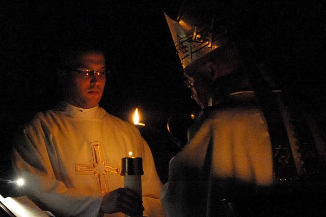 Bishop Richard J. Malone lights the Paschal Candle at the start of the Easter Vigil at St. Joseph Cathedral, Buffalo, on Saturday night.