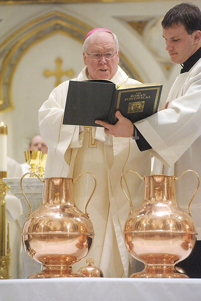 Bishop Richard J. Malone blesses the urns of oil during the Chrism Mass at St. Joseph Cathedral. 