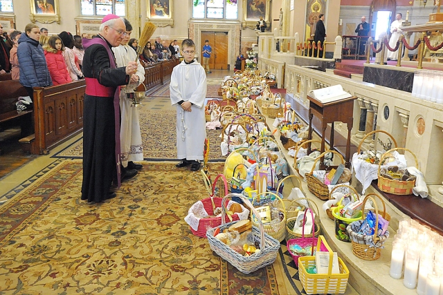 Bishop Richard J. Malone blesses baskets of food at Corpus Christi Church, Buffalo. In many Eastern European countries, it is a tradition to have a basket of food blessed on Holy Saturday or Easter Sunday. 