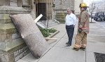 Michael Sullivan, director of diocesan buildings and properties, and Buffalo Fire Department Lt. Phil Losi inspect the burned piece of plywood that started the fire inside St. Joseph Cathedral on Friday morning. (Photo by Patrick McPartland)