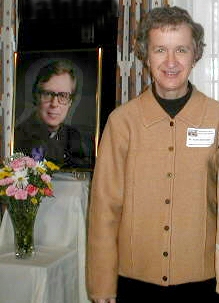 Sr. Karen Klimczak beside a portrait of Father Joseph Bissonette whom Bissonette House is named for.
