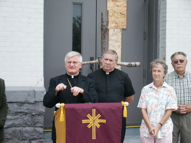 Sister Karen Klimczak (right), SSJ, joins Auxiliary Bishop Edward Grosz (left), and Father Roy Herberger, pastor, at a press conference regarding the fate of SS. Columba-Brigid Church. The church was damaged by fire in 2004.