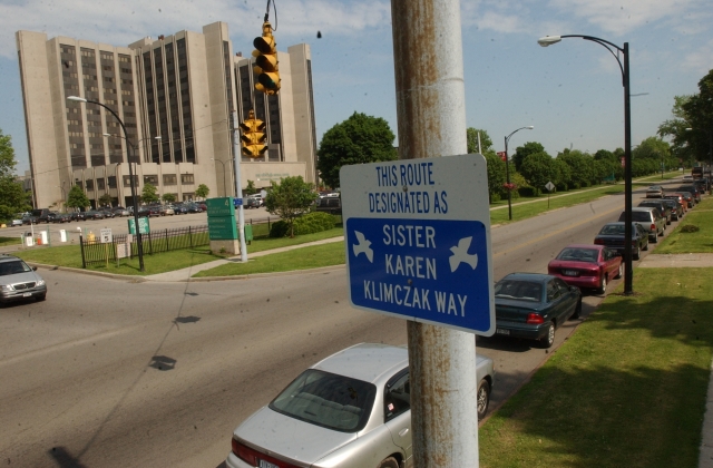 A street sign hangs on Grider Street in Buffalo in memory of Sister Karen Klimczak, SSJ. The sign hangs outside Bissonette House where Sr. Karen worked with recently released prison inmates.