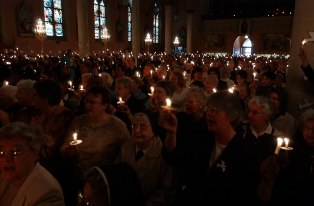 Mourners hold candles a the funeral for Sister Karen Klimczak, SSJ, at St. Ann Church, Buffalo, April 22, 2006.