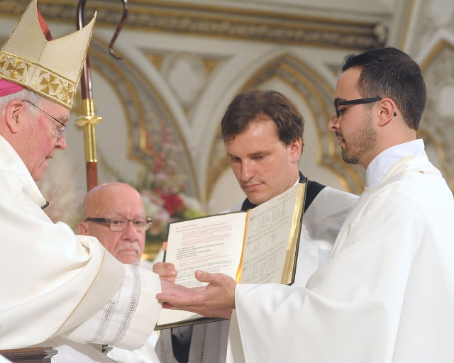 The hands of Father Samuel Giangreco are blessed with oil and bound by Bishop Richard J. Malone during the Sacrament of Ordination at St. Joseph Cathedral on May 28, 2016.
