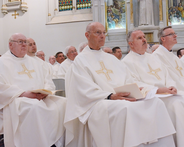 Priests of the diocese witness the ordination of three more to their brotherhood at St. Joseph Cathedral on May 28, 2016.
