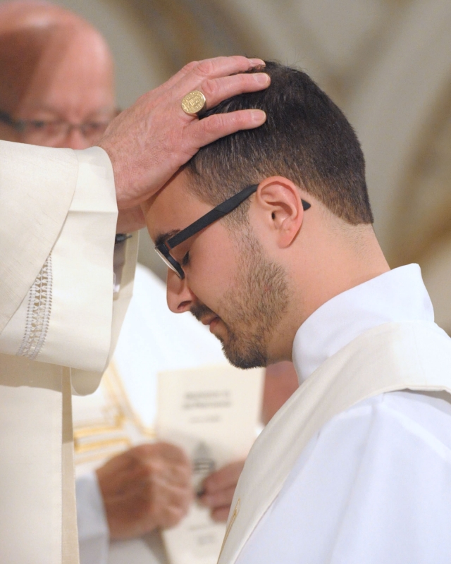 Bishop Richard J. Malone places his hand on the head of Father Samuel Giangreco during ordination ceremonies at St. Joseph Cathedral on May 28, 2016.
