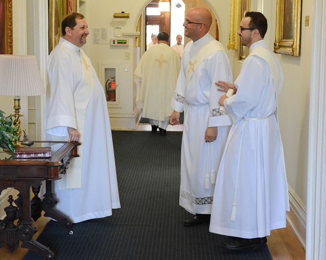 Candidates for ordination Rev. Mr. Michael Brown (left to right), Rev. Mr. Michael LaMarca and Rev. Mr. Samuel Giangreco share some laughs together before their ordination to the priesthood at St. Joseph Cathedral on May 28, 2016.