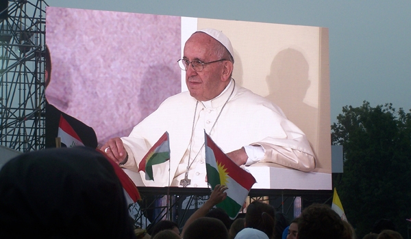 Pope Francis is shown on one of the giant video screens in Krakow's Blonia Park. The pope made his first public appearance of World Youth Day at a welcoming ceremony, to deliver a message of encouragement to teen and young adult Catholics from around the 