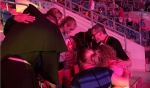 Father David Baker leads a prayer with a group of World Youth Day pilgrims from St. Amelia Parish in Tonawanda while at Tauron Arena in Krakow. The parish regularly prays for its pilgrims at 9:30 a.m. Buffalo time, so the pilgrims pray simultaneously in P