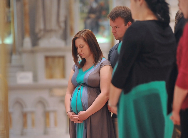 Sarah Sporski and her husband Daren from Our Lady of Hope, Buffalo, receive the Rite of the Blessing of a Child in the Womb from Bishop Richard J. Malone during a special Mass at St. Joseph Cathedral on May 5, 2013. The Mass was sponsored by Office of Pro-Life Activities and the St. Gianna Molla Pregnancy Outreach Center.
