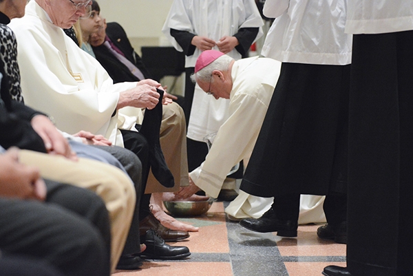 Bishop Richard J. Malone participates in the washing of feet at St. Joseph Cathedral during Evening Mass of the Lord's Supper. (Patrick McPartland/Managing Editor)