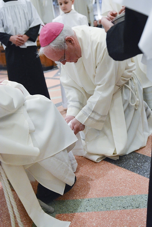 Bishop Richard J. Malone participates in the washing of feet at St. Joseph Cathedral during Evening Mass of the Lord's Supper. (Patrick McPartland/Managing Editor)