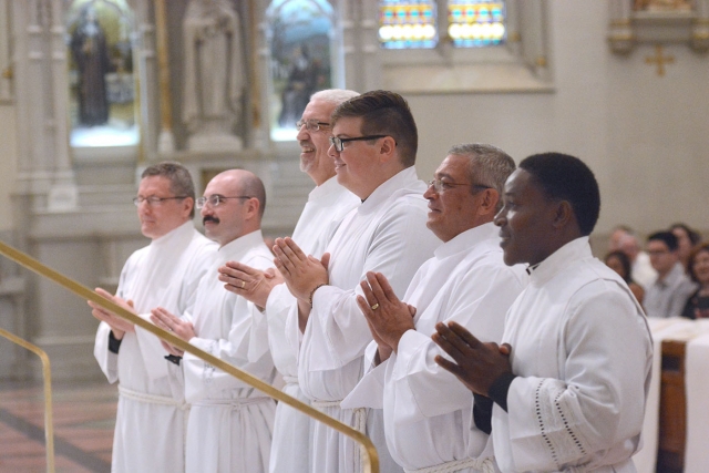 Gerard Skrzynski (from left), Peter Santandreu, Kenneth Monaco, Paul Cygan, Edward Birmingham and Peter Bassey answer the call of Bishop Richard J. Malone to affirm their readiness to function in the ministry of diaconate service. (Patrick McPartland/Managing Editor)